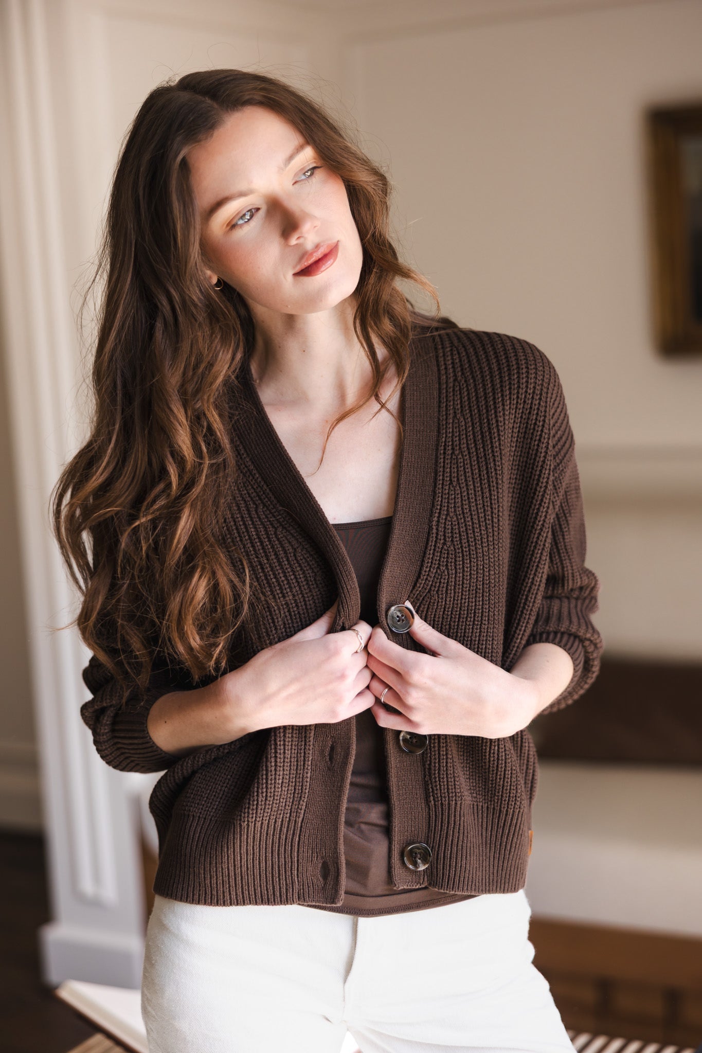Woman with her head tilted holding the sides of her cardigan in espresso
::: Model is 5'8" wearing size XS ///