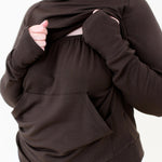 The front fabric of the Women's French Terry Nursing Hoodie in Espresso pulled up showing the elastic band front for easy pulldown for nursing