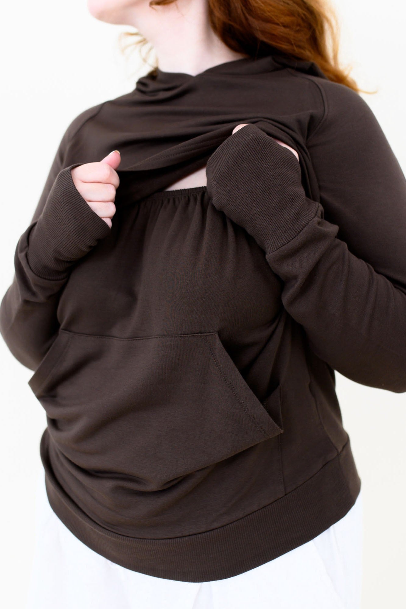 The front fabric of the Women's French Terry Nursing Hoodie in Espresso pulled up showing the elastic band front for easy pulldown for nursing