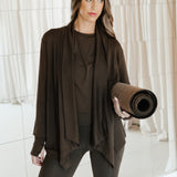 Female holding a yoga mat wearing the Bamboo Flex Women’s Leggings in Espresso and matching short sleeve tee and french terry wrap top