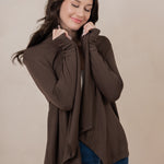 Woman holding the Women's French Terry Wrap Top in Espresso close towards her face with eyes closed
