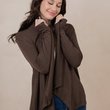 Woman holding the Women's French Terry Wrap Top in Espresso close towards her face with eyes closed
