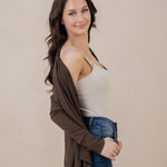 Model smiling at the camera while wearing the Women's French Terry Wrap Top in Espresso off her shoulder