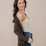 Model smiling at the camera while wearing the Women's French Terry Wrap Top in Espresso off her shoulder