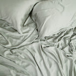 Close up of the Bamboo Sateen Sheet Set in Eucalyptus shown on a bed