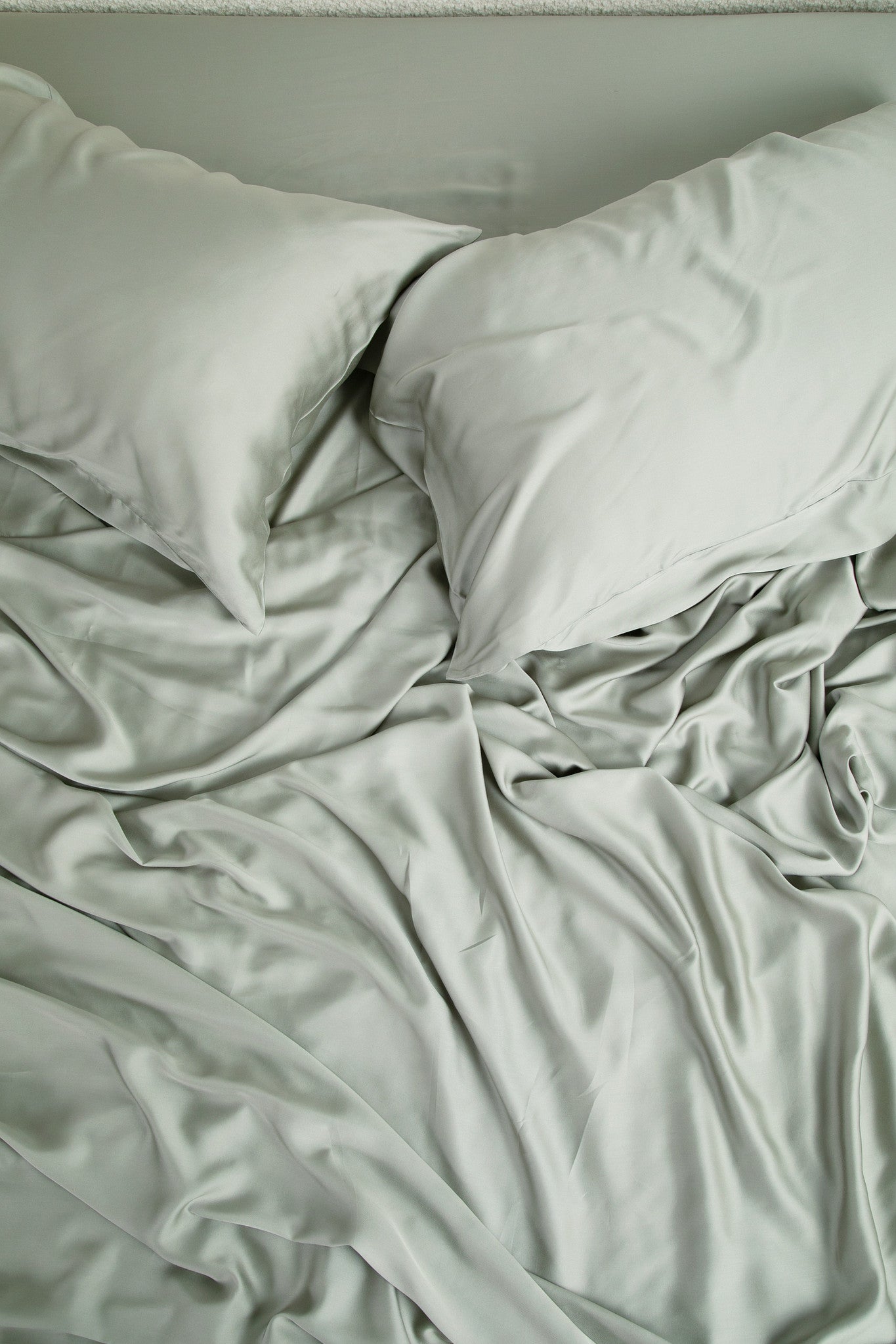 Close up of the Bamboo Sateen Sheet Set in Eucalyptus shown on a bed