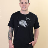 Male modeling the Men's Crew Neck Tee in Millennium Falcon™ with one hand in his jean pocket