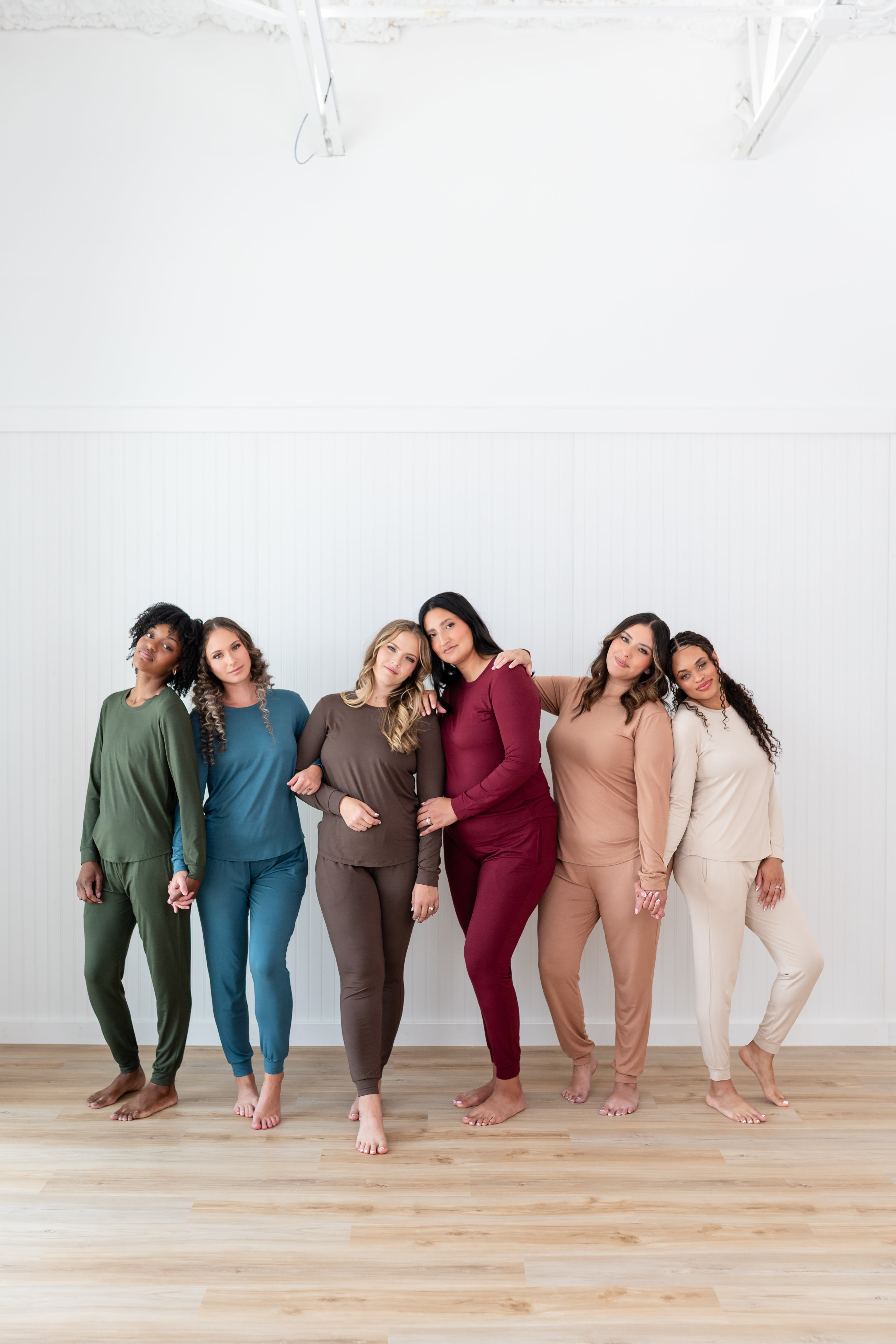Models standing in a row wearing Women's  Jogger Pajama Sets in Fir, Atlantic, Espresso, Burgundy, Latte and Bisque