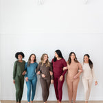 Models with linked arms in  Kyte Women's Jogger Sets in Fir, Atlantic, Espresso, Burgundy, Latte and Bisque