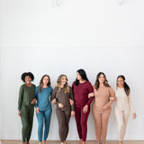 Models with linked arms in  Kyte Women's Jogger Sets in Fir, Atlantic, Espresso, Burgundy, Latte and Bisque