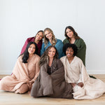Models wrapped in Quilt Blankets in Fall Solids: Burgundy, Atlantic, Fir, Latte, Coffee and Bisque