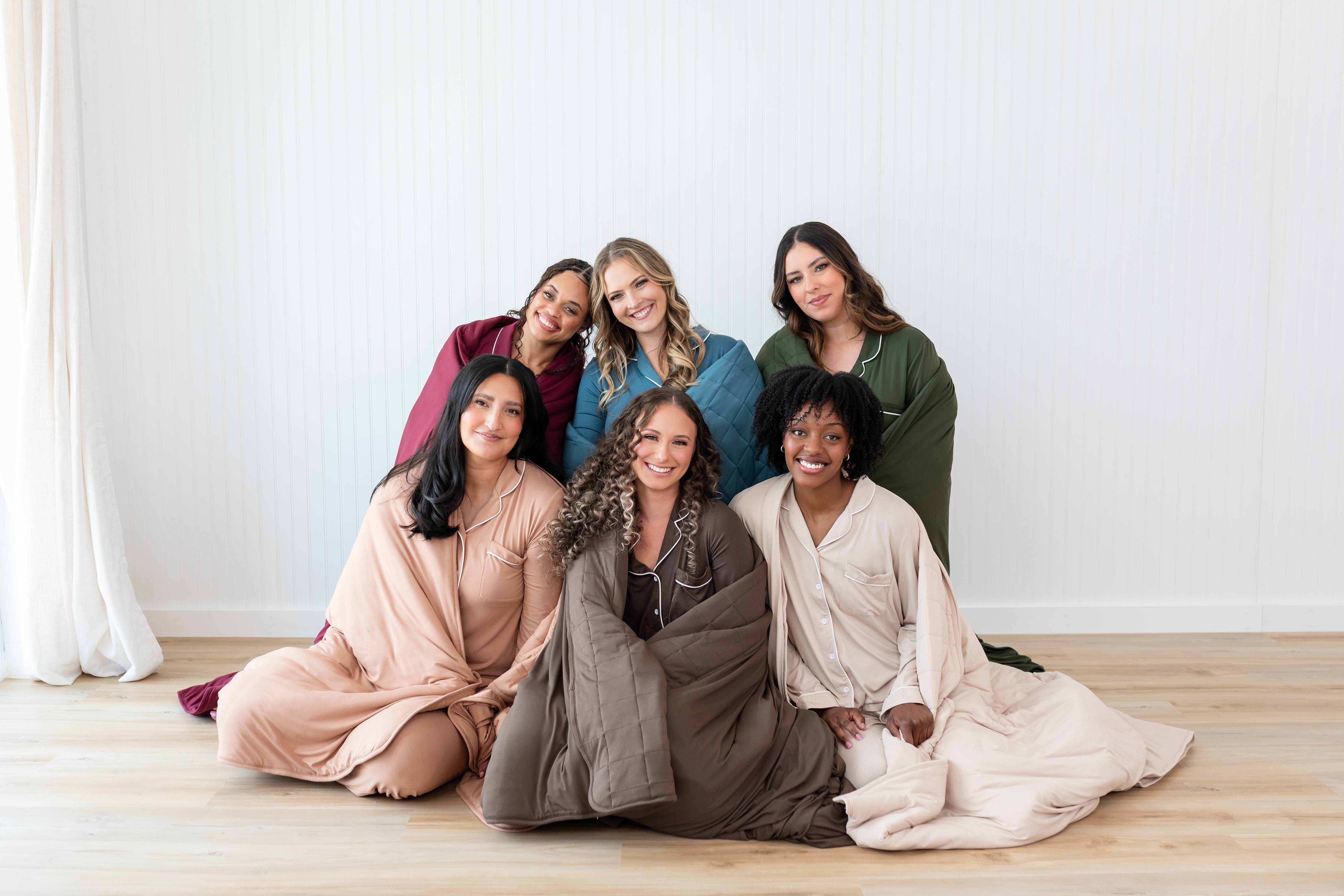 Models wrapped in Quilt Blankets in Fall Solids: Burgundy, Atlantic, Fir, Latte, Coffee and Bisque