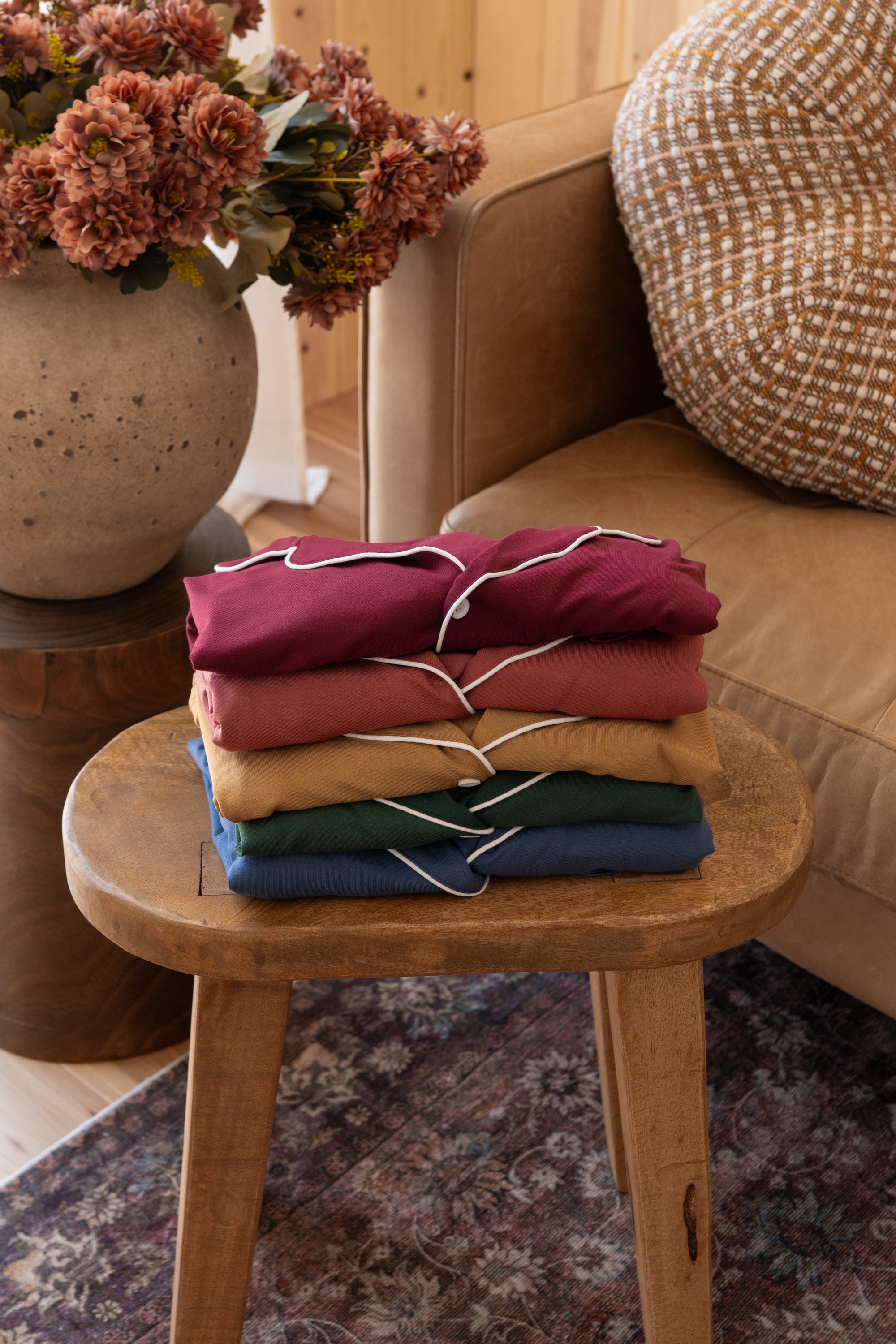 stack of button up pajamas in a fall color palette  