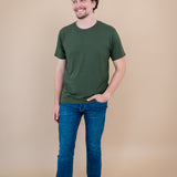 Male model stepping and looking to the side while wearing Kyte Men's Crew Neck Tee in Fir