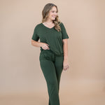 Smiling model wearing the Women's Lounge Pants in Fir and matching Women's V-Neck