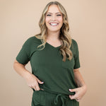 Smiling model wearing the Women's V Neck in Fir 