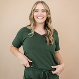 Smiling model wearing the Women's V Neck in Fir 