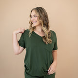 Smiling woman looking to the side while modeling the Women's V Neck in Fir and matching lounge pants