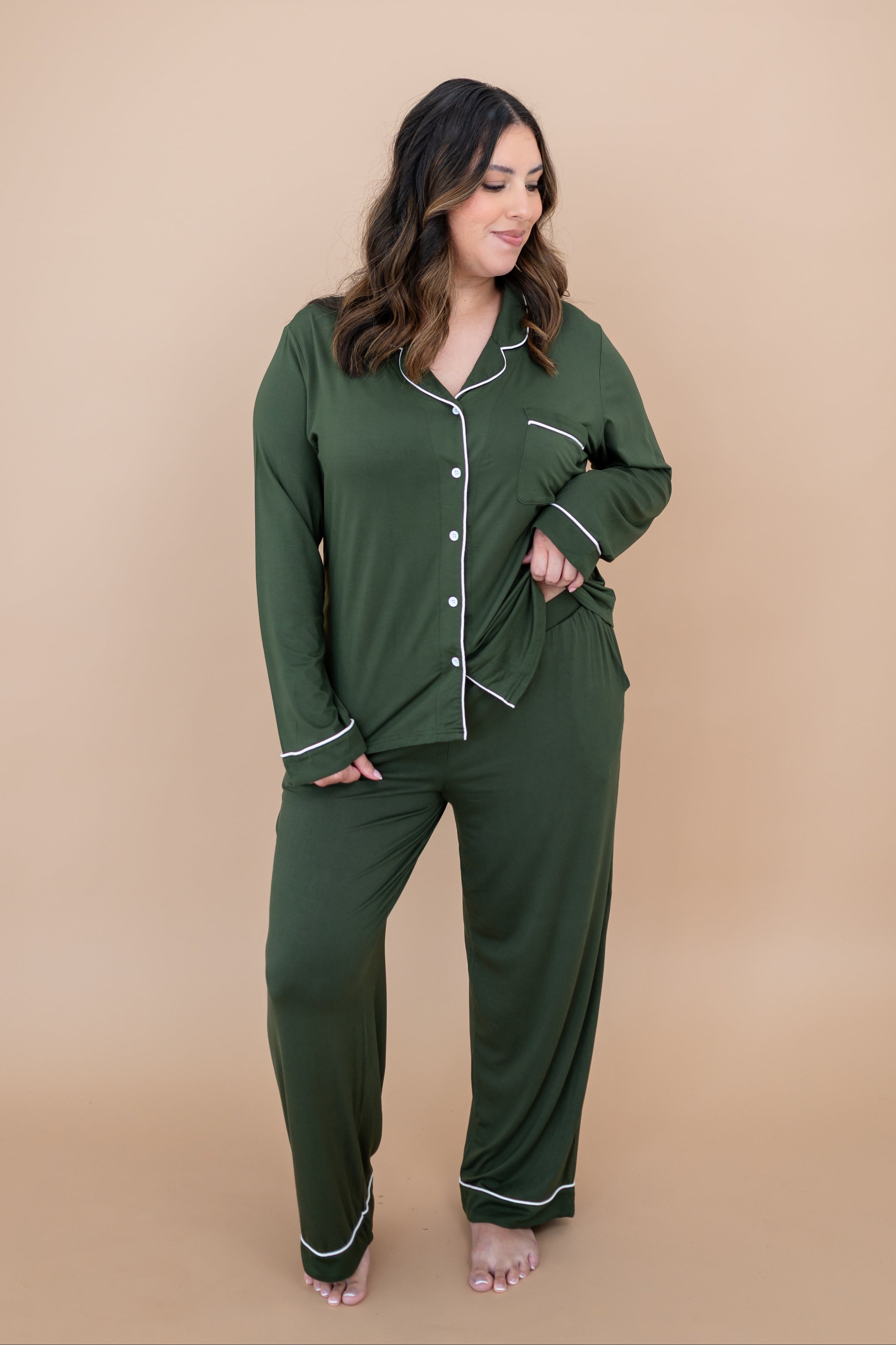 Smiling model looking down to the side while wearing the Women's Long Sleeve Pajama Set in Fir