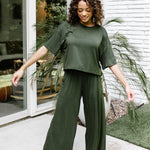 Woman modeling the Kyte Women's Wide Leg Pant in Fir with matching short sleeve tee
