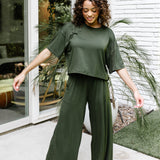 Woman modeling the Kyte Women's Wide Leg Pant in Fir with matching short sleeve tee