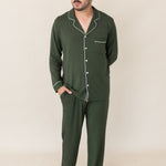 Model with hand in pocket while wearing the Kyte Men's Long Sleeve Pajama Set in Fir
