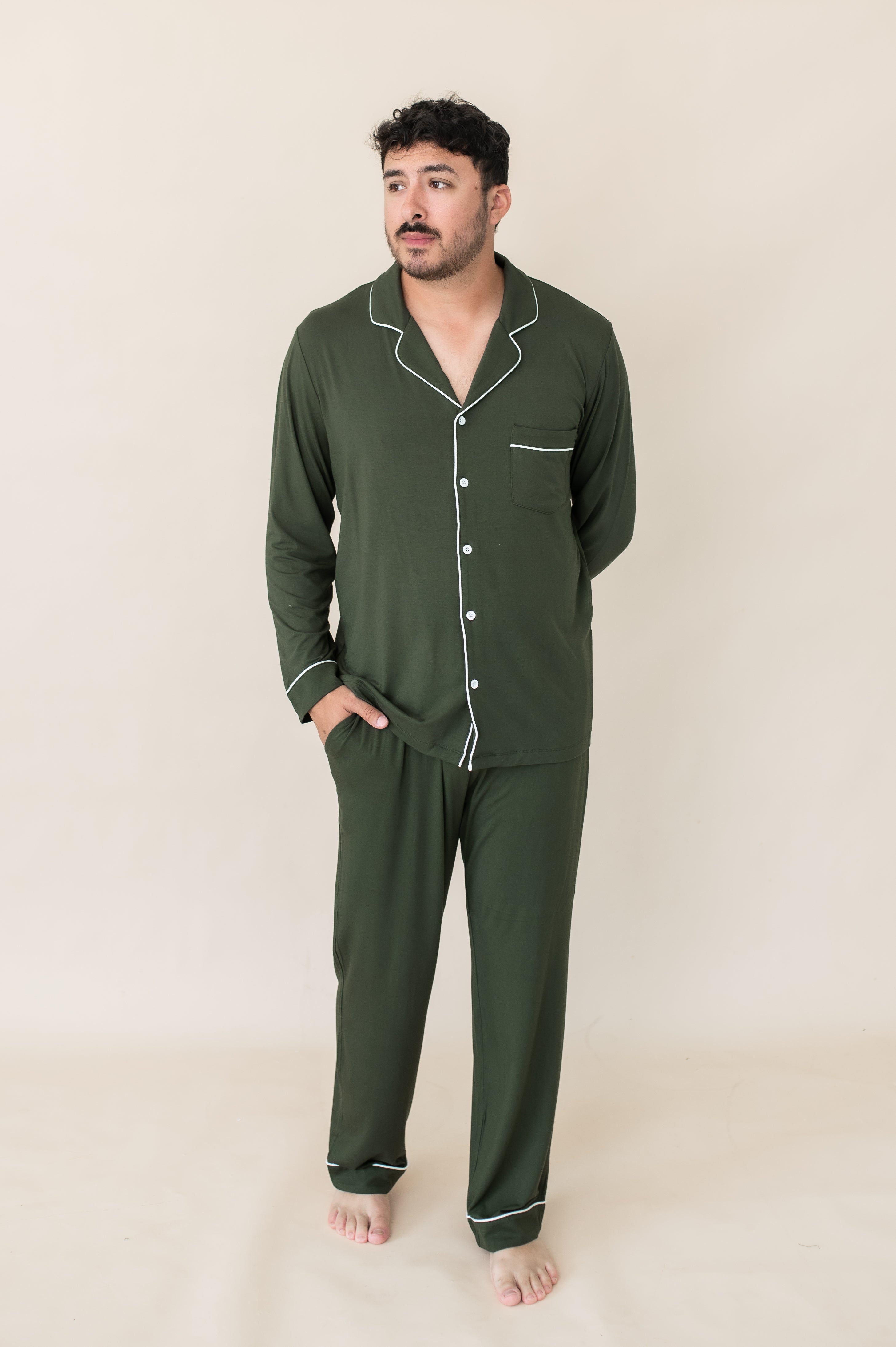 Model with hand in pocket while wearing the Kyte Men's Long Sleeve Pajama Set in Fir