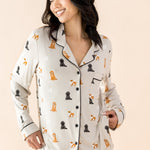 The shirt of the Long-Sleeved Women's Pajama Set in Fluffy Dog shown on a smiling female model