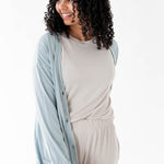 Female modeling the Bamboo Jersey Adult Cardigan in Fog paired with Oat shirt and pants