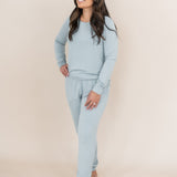 Model looking upwards to the side while wearing the Kyte Woman's Jogger Set in Fog