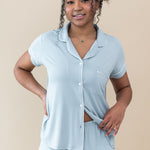 Female showcasing button placement on Women's Short Sleeve Pajama Set in Fog with Cloud Trim