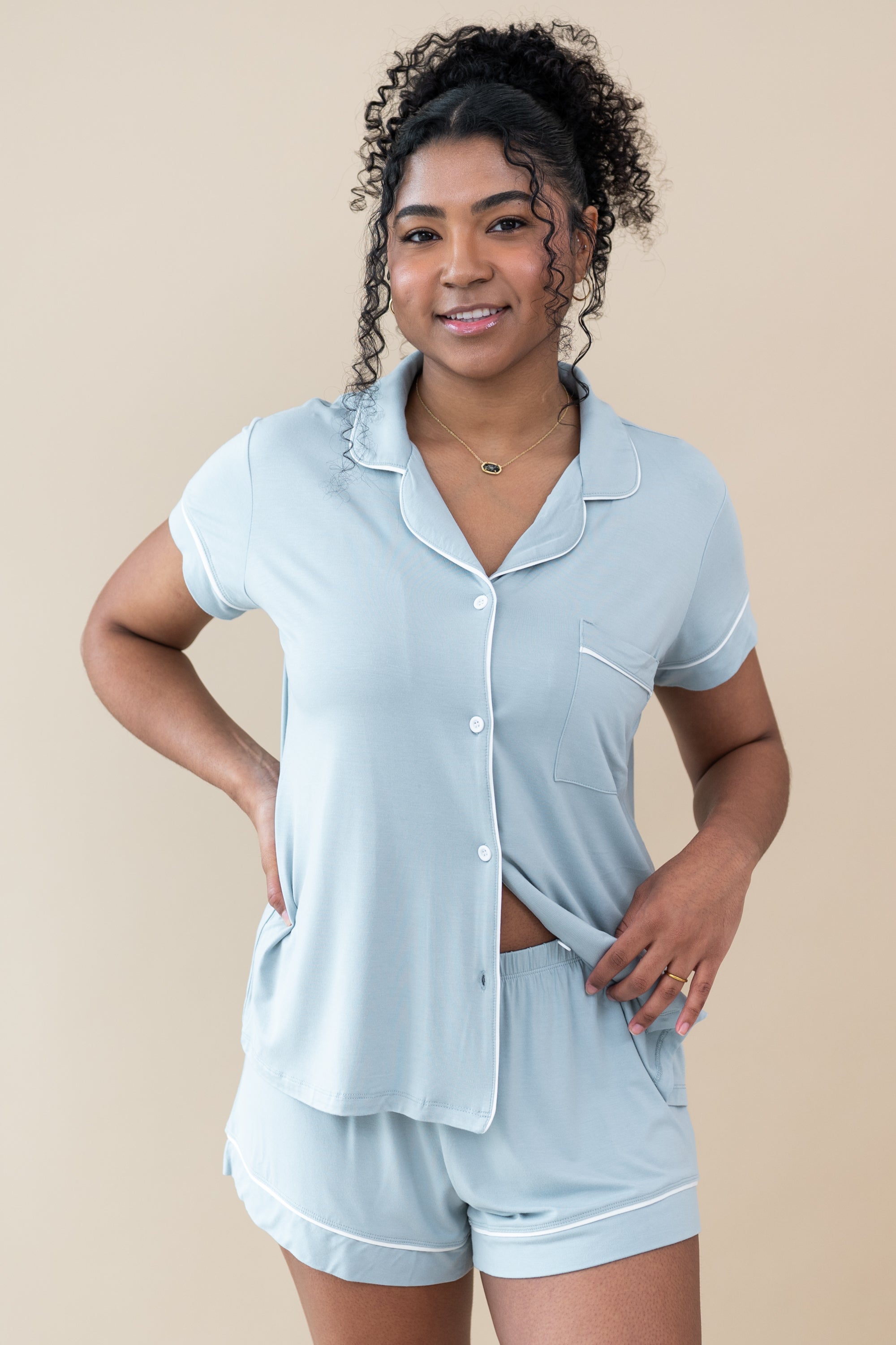 Female showcasing button placement on Women's Short Sleeve Pajama Set in Fog with Cloud Trim