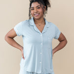 Female model in Kyte Baby's Women's Short Sleeve Pajama Set in Fog with Cloud Trim