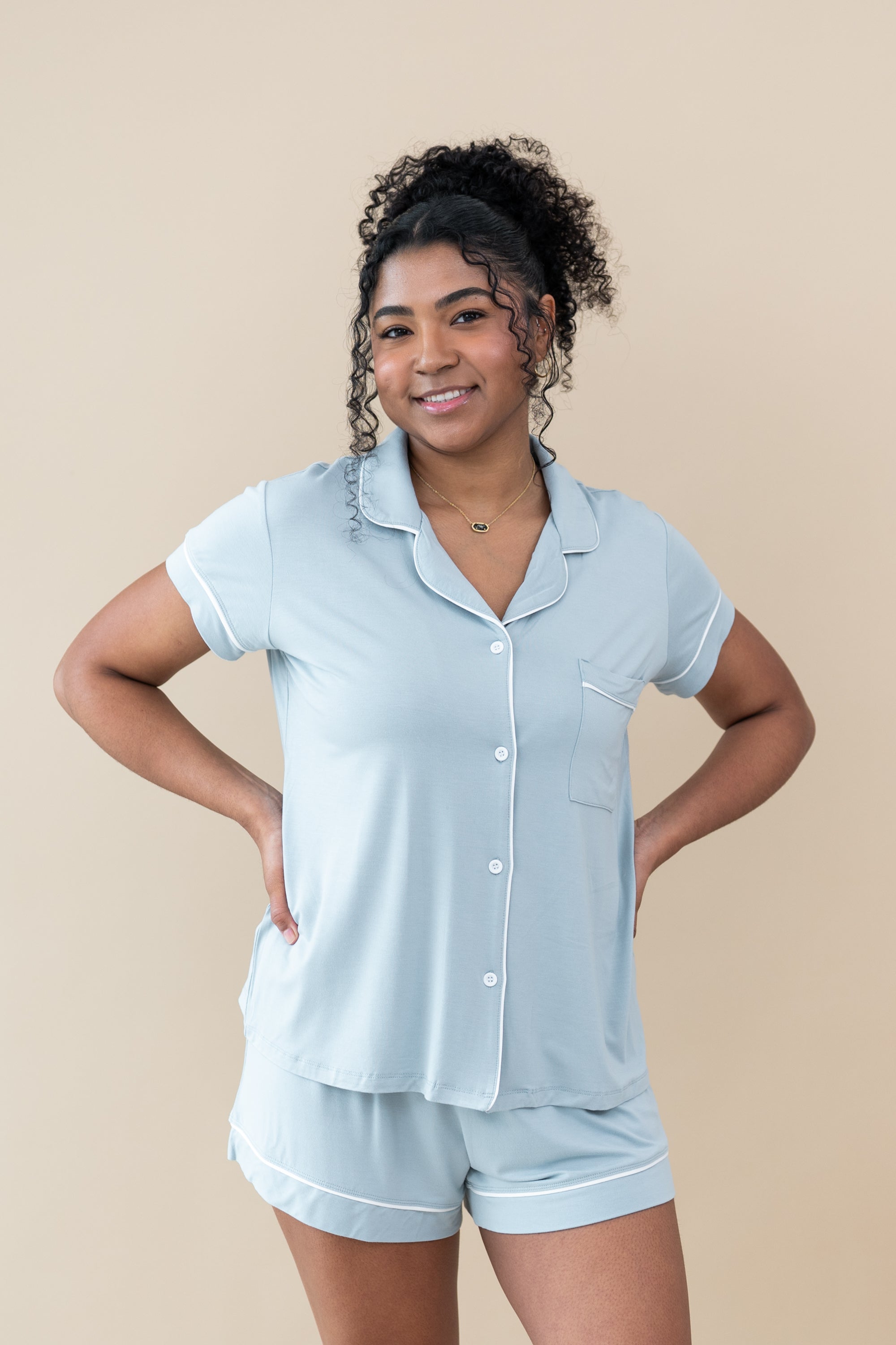 Female model in Kyte Baby's Women's Short Sleeve Pajama Set in Fog with Cloud Trim