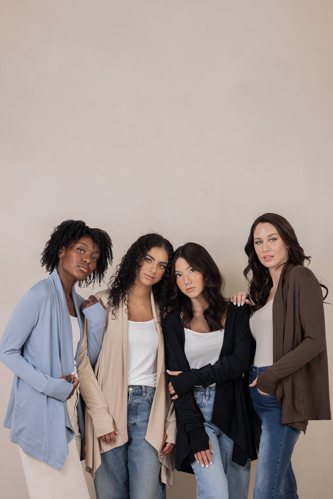Models standing next to each other while wearing the Women's French Terry Wrap Top in Slate, Almond, Midnight and Espresso
