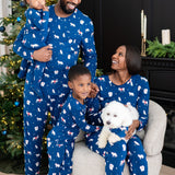 Family of 4 and dog all wearing matching holiday pajamas that are blue with a winter forest animal print