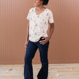 Woman modeling the Women's Relaxed Fit V-Neck in Gilmore Girls paired with dark jeans