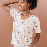 Model looking to the side with one hand in hair while modeling the Kyte Women's Relaxed Fit V-Neck in Gilmore Girls