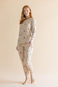 Woman standing infront of a beige background while modeling the Women's Jogger Pajama Set in Gilmore Girls