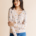 Woman with arms crossed in front of her body while modeling the Women's Long Sleeve Henley Tee in Gilmore Girls paired with jeans