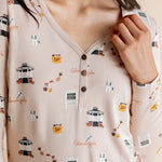 Close up of the Women's Long Sleeve Henley Tee in Gilmore Girls showcasing the buttons and print on a model 