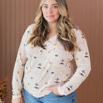 Model wearing the Kyte Women's Long Sleeve Henley Tee in Gilmore Girls paired in light jeans with her hand in her pocket
