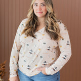 Model wearing the Kyte Women's Long Sleeve Henley Tee in Gilmore Girls paired in light jeans with her hand in her pocket