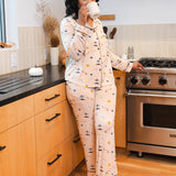 Woman drinking from a mug in a kitchen while wearing the Long-Sleeved Women's Pajama Set in Gilmore Girls
::: Model is 5'8" wearing size M ///