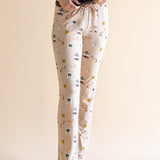 Close up of the Women's Lounge Pants in Gilmore Girls paired with a cami with hands on waistband 