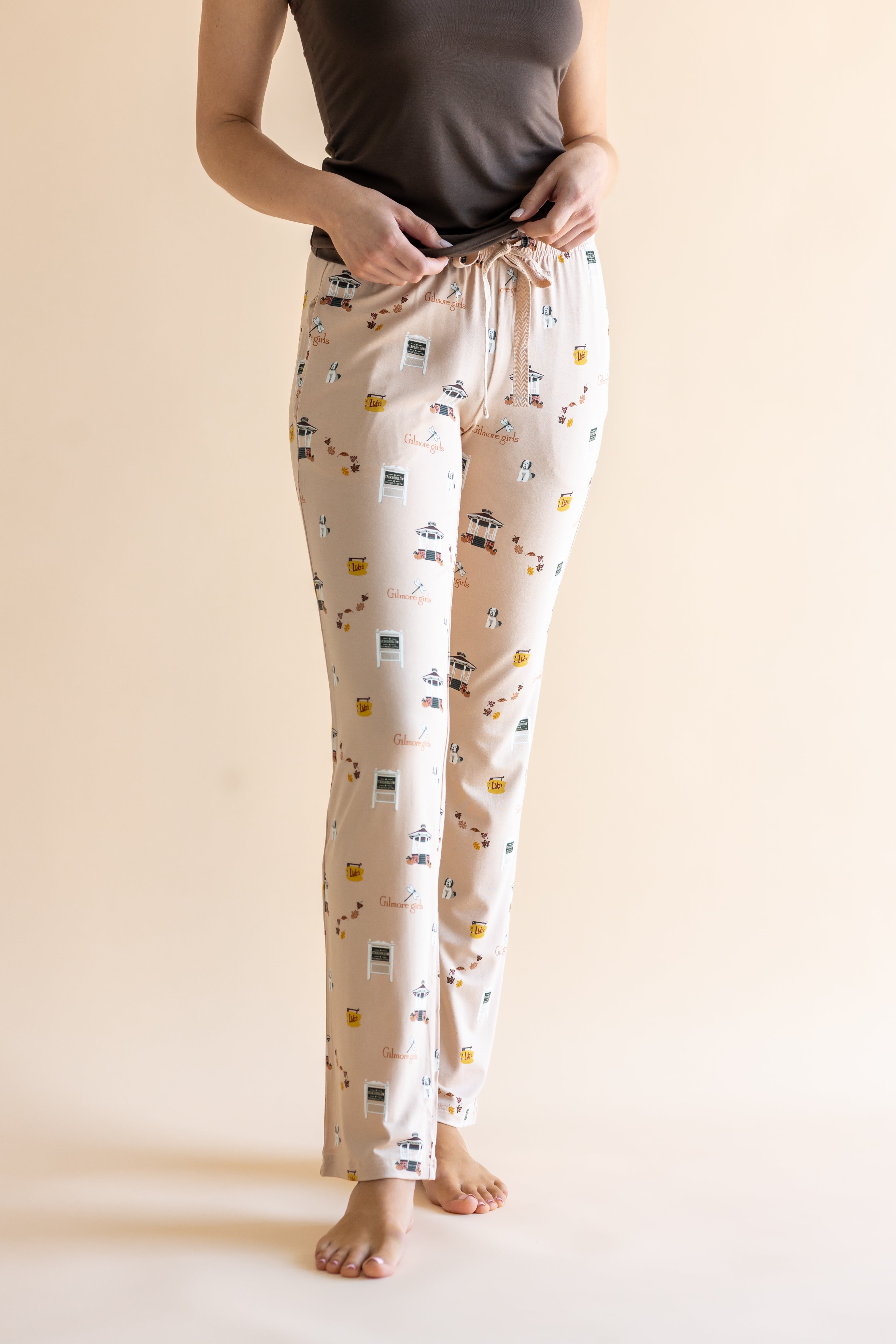 Close up of the Women's Lounge Pants in Gilmore Girls paired with a cami with hands on waistband 