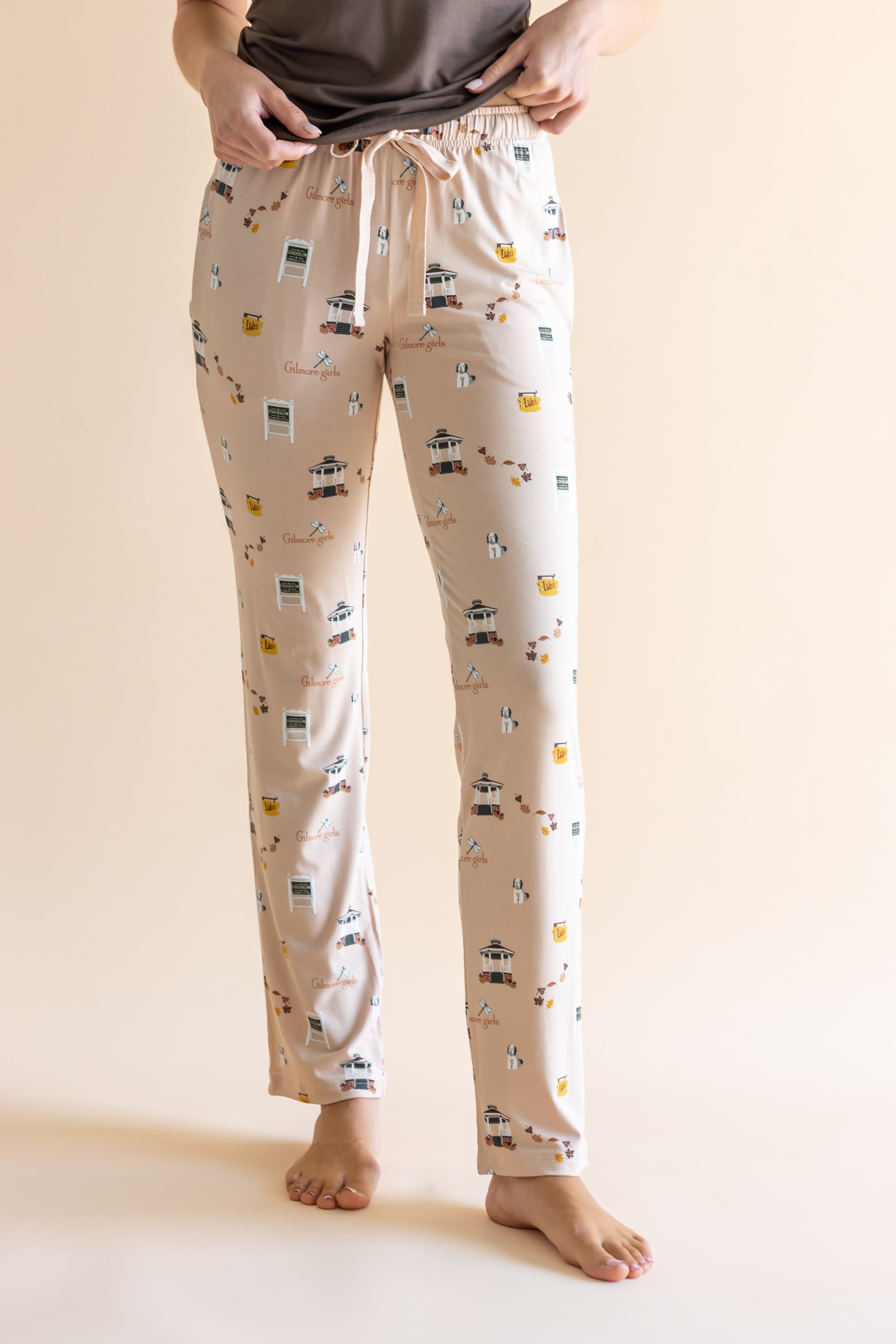 Close up of the Women's Lounge Pants in Gilmore Girls on a model standing in front of a beige background