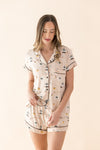 Woman wearing a Gilmore Girls patterned pajama set on a beige background  ::: Model is 5'11" wearing size S ///