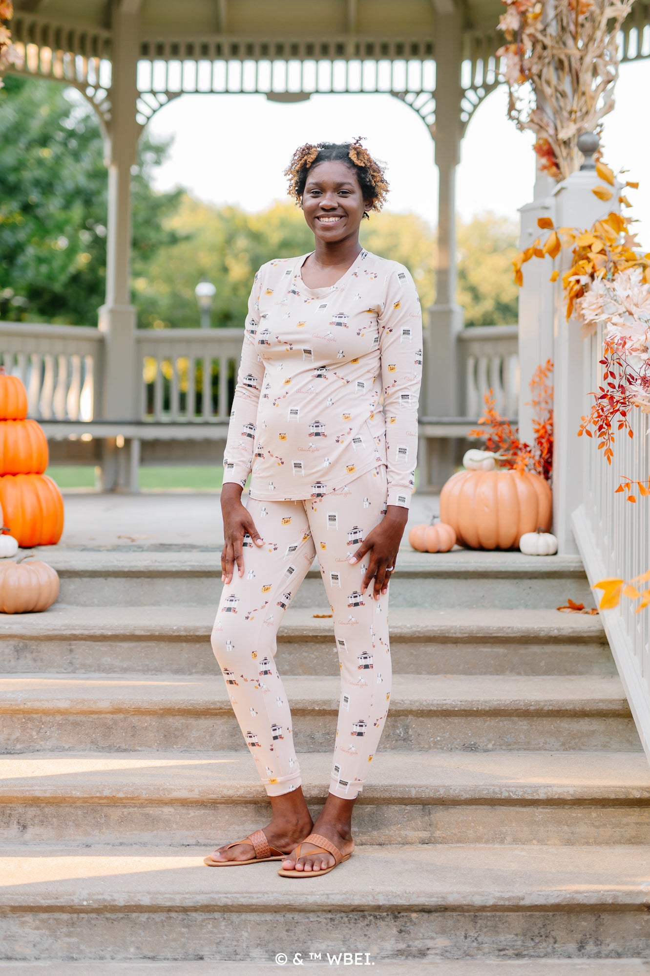 Model standing on gazebo stairs wearing the Women's Jogger Pajama Set in Gilmore Girls