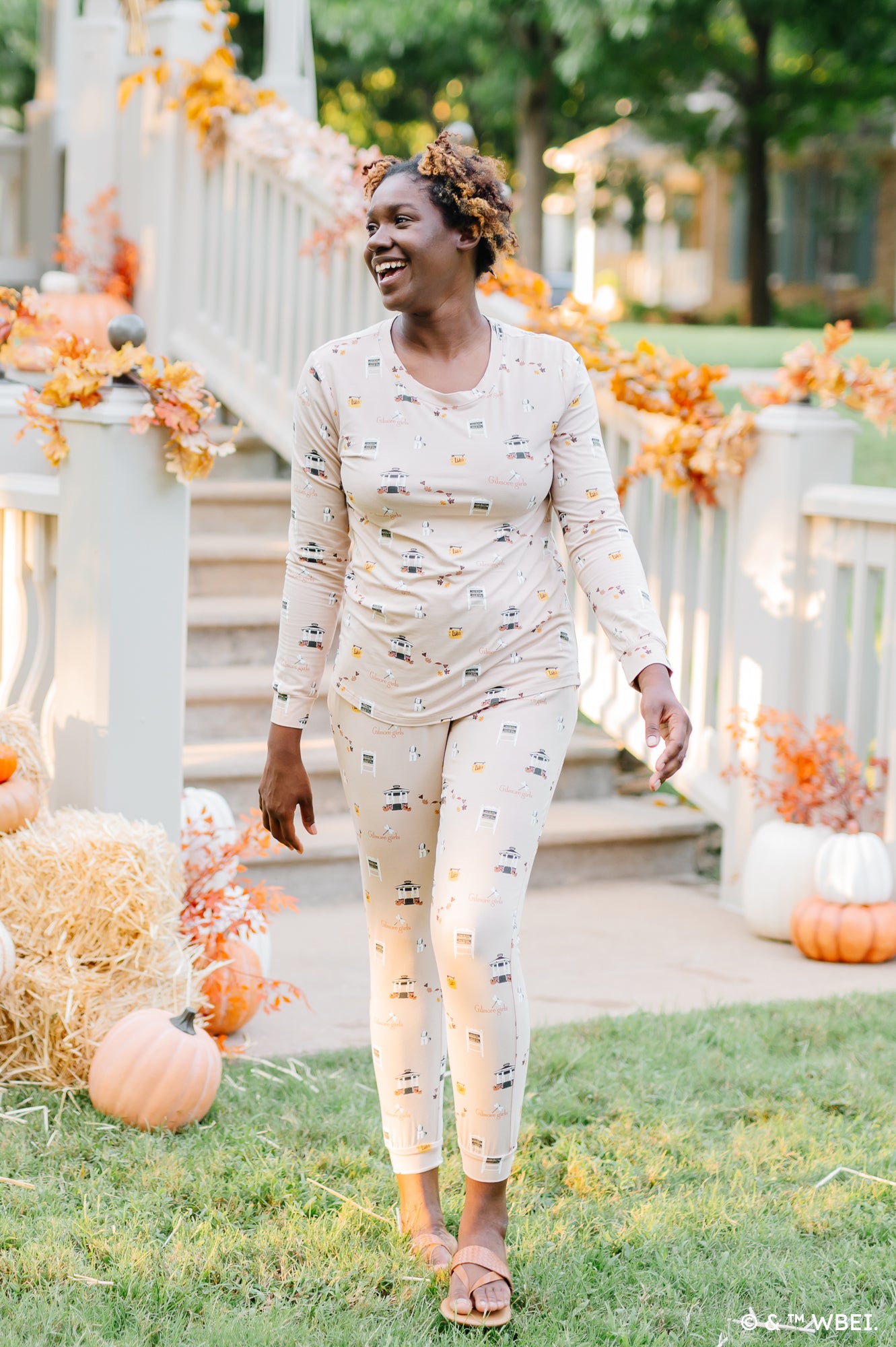 Model walking while smiling and looking to the side while wearing the Women's Jogger Pajama Set in Gilmore Girls